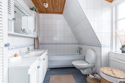 Badrum med vägghängd wc och badkar